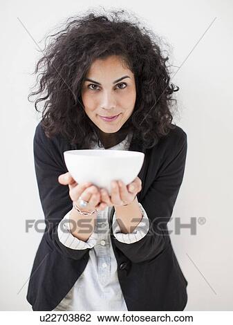 Portrait of beautiful young woman holding bowl View Large Photo Image Stock Image - Portrait of beautiful young woman holding bowl. Fotosearch