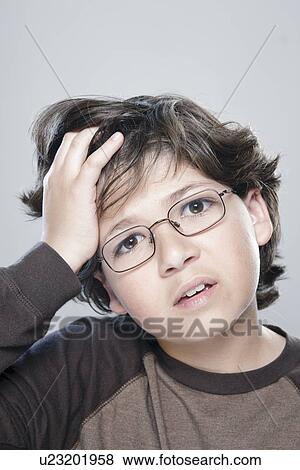 Stock Photo - Portrait of boy (10-11), studio shot. Fotosearch