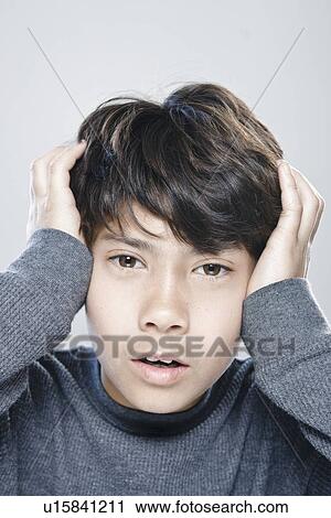 Stock Image - Portrait of boy (12-13) expressing stress. Fotosearch