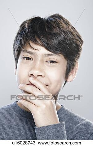 Stock Image - Portrait of boy (12-13) expressing positively. Fotosearch