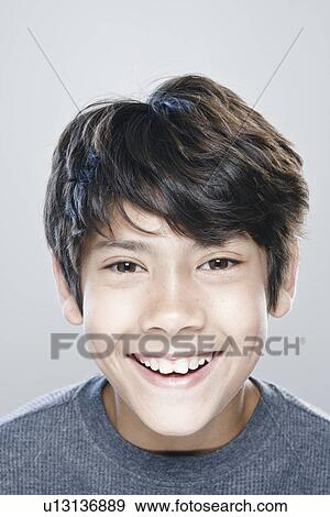 Portrait of boy (12-13) expressing positively View Large Photo Image Stock Photo - Portrait of boy (12-13) expressing positively. Fotosearch