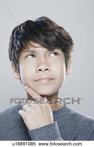 Stock Photography - Portrait of boy (12-13) expressing contemplation. Fotosearch