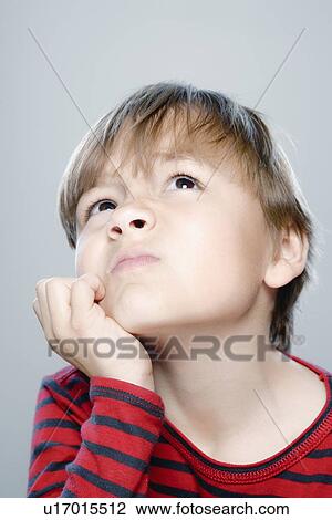 Stock Image - Portrait of boy (6-7), studio shot. Fotosearch