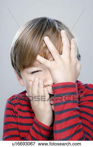 Stock Photo - Portrait of boy (6-7), studio shot. Fotosearch