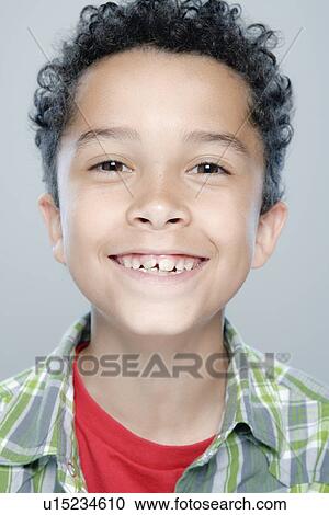 Stock Image - Portrait of boy (8-9), studio shot. Fotosearch