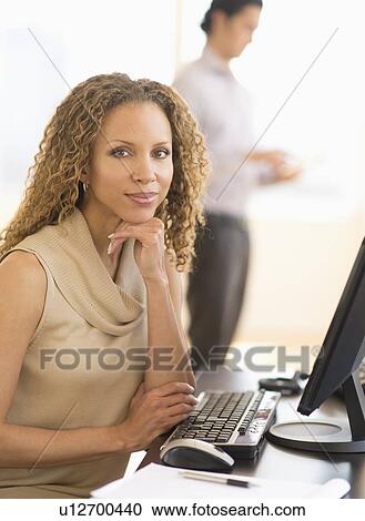 Portrait of business woman using computer View Large Photo Image Stock Image - Portrait of business woman using computer. Fotosearch