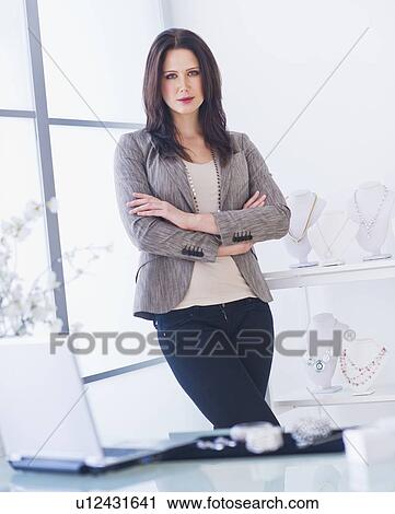 Stock Image - Portrait of businesswoman in office. Fotosearch