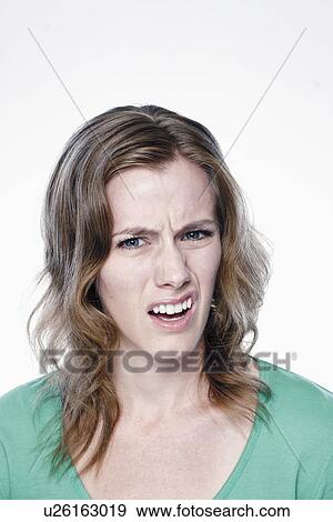 Portrait of confused young woman, studio shot View Large Photo Image Stock Photo - Portrait of confused young woman, studio shot. Fotosearch