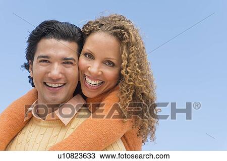 Portrait of couple against blue sky View Large Photo Image Stock Image - Portrait of couple against blue sky. Fotosearch