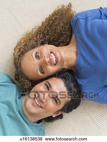 Portrait of couple lying on floor View Large Photo Image Stock Photo - Portrait of couple lying on floor. Fotosearch