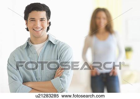 Stock Photography - Portrait of couple with focus on man in foreground. Fotosearch