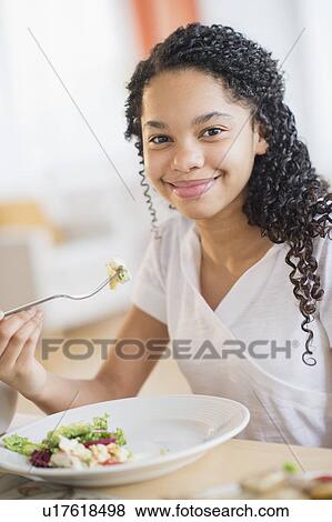 Portrait of girl (10-11) eating dinner View Large Photo Image Stock Photo - Portrait of girl (10-11) eating dinner. Fotosearch