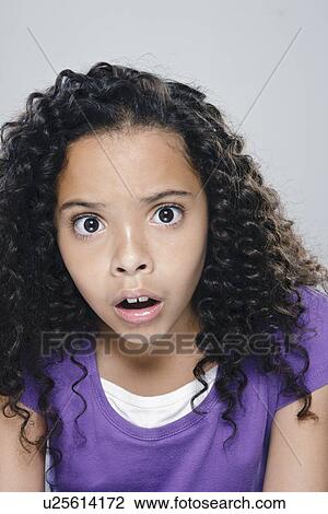 Stock Image - Portrait of girl (10-11), studio shot. Fotosearch