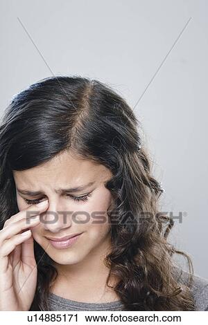 Stock Image - Portrait of girl (12-13), studio shot. Fotosearch