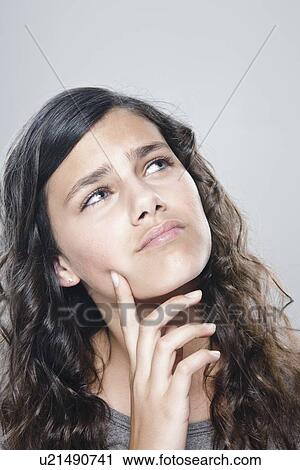 Stock Image - Portrait of girl (12-13), studio shot. Fotosearch