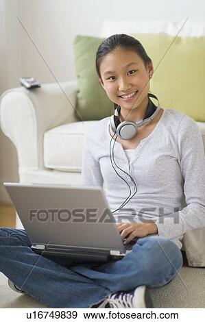 Portrait of girl (14-15) using laptop at home View Large Photo Image Stock Photo - Portrait of girl (14-15) using laptop at home. Fotosearch