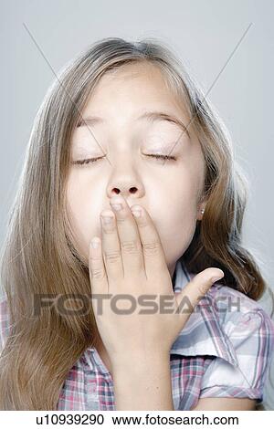 Stock Image - Portrait of girl (6-7), studio shot. Fotosearch