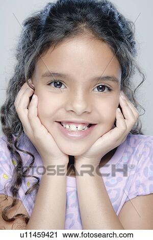 Stock Image - Portrait of girl (6-7), studio shot. Fotosearch