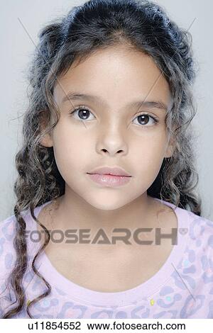 Stock Image - Portrait of girl (6-7), studio shot. Fotosearch