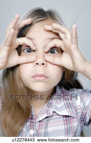 Stock Image - Portrait of girl (6-7), studio shot. Fotosearch