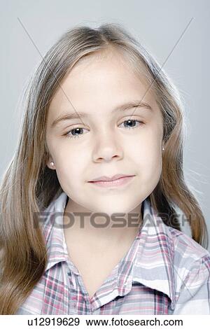 Stock Photo - Portrait of girl (6-7), studio shot. Fotosearch
