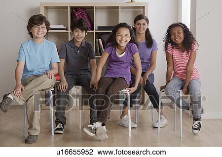 Portrait of grinning pupils sitting in classroom View Large Photo Image Stock Image - Portrait of grinning pupils sitting in classroom. Fotosearch