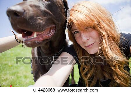Stock Photo - Portrait of happy young woman and her dog. Fotosearch