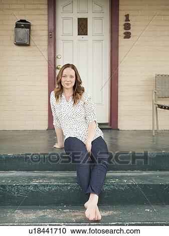 Portrait of happy young woman standing on porch View Large Photo Image Stock Image - Portrait of happy young woman standing on porch. Fotosearch