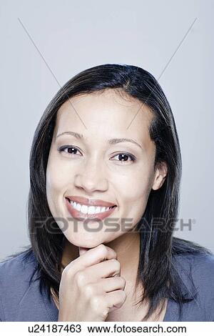Portrait of happy young woman, studio shot View Large Photo Image Stock Image - Portrait of happy young woman, studio shot. Fotosearch