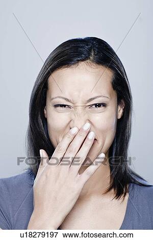Stock Photo - Portrait of happy young woman, studio shot. Fotosearch