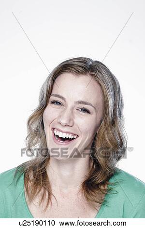 Portrait of laughing young woman, studio shot View Large Photo Image Stock Image - Portrait of laughing young woman, studio shot. Fotosearch