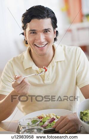 Portrait of man eating dinner View Large Photo Image Stock Photo - Portrait of man eating dinner. Fotosearch