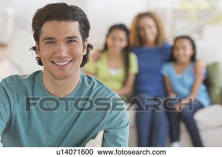 Portrait of man with wife and daughters (10-13) in background View Large Photo Image Stock Image - Portrait of man with wife and daughters (10-13) in background. Fotosearch