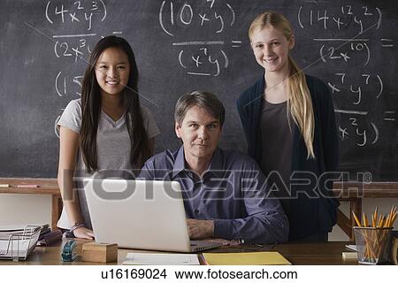 Picture - Portrait of maths teacher with two students (14-15). Fotosearch