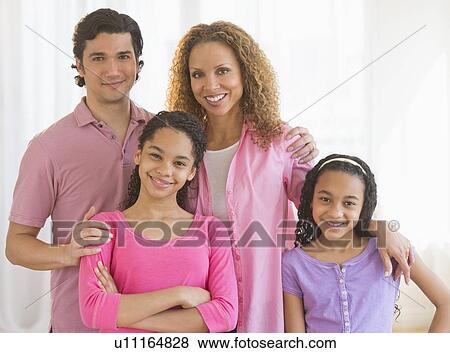 Stock Photo - Portrait of parents with daughters (10-13). Fotosearch