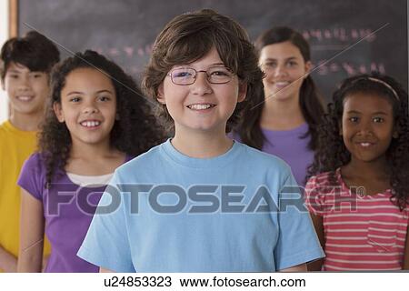 Portrait of pupils (10-11, 12-13) with blackboard in background View Large Photo Image Stock Image - Portrait of pupils (10-11, 12-13) with blackboard in background. Fotosearch