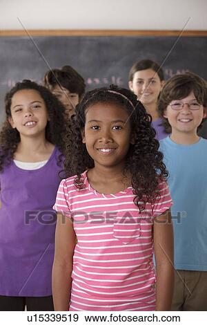 Portrait of pupils (10-11, 12-13) with blackboard in background View Large Photo Image Stock Photo - Portrait of pupils (10-11, 12-13) with blackboard in background. Fotosearch