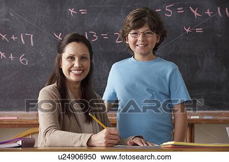 Portrait of schoolboy (10-11) and teacher with blackboard in background View Large Photo Image Stock Image - Portrait of schoolboy (10-11) and teacher with blackboard in background. Fotosearch