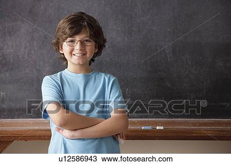 Portrait of schoolboy (10-11) in front of blackboard View Large Photo Image Stock Image - Portrait of schoolboy (10-11) in front of blackboard. Fotosearch