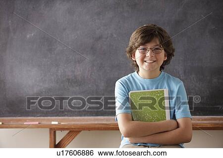 Portrait of schoolboy (10-11) in front of blackboard View Large Photo Image Stock Photograph - Portrait of schoolboy (10-11) in front of blackboard. Fotosearch
