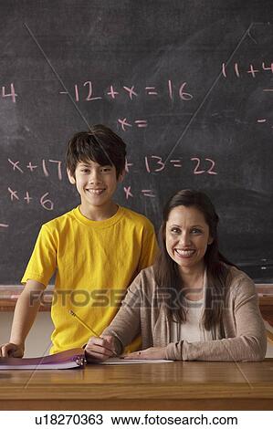 Portrait of schoolboy (12-13) and teacher with blackboard in background View Large Photo Image Stock Image - Portrait of schoolboy (12-13) and teacher with blackboard in background. Fotosearch