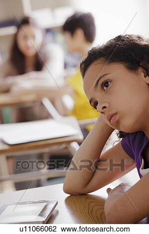 Stock Image - Portrait of schoolgirl (10-11) contemplating. Fotosearch