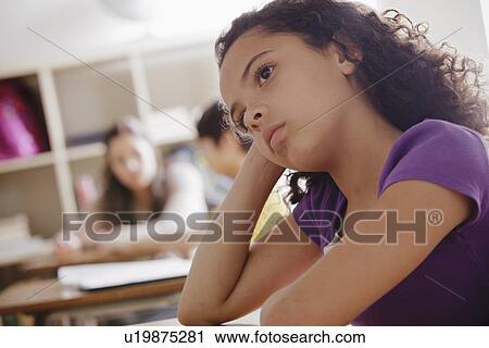 Stock Image - Portrait of schoolgirl (10-11) contemplating. Fotosearch