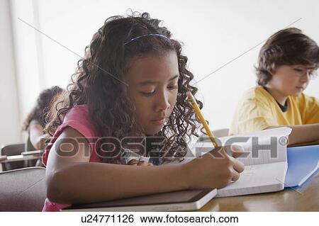Portrait of schoolgirl (10-11) writing View Large Photo Image Stock Photograph - Portrait of schoolgirl (10-11) writing. Fotosearch