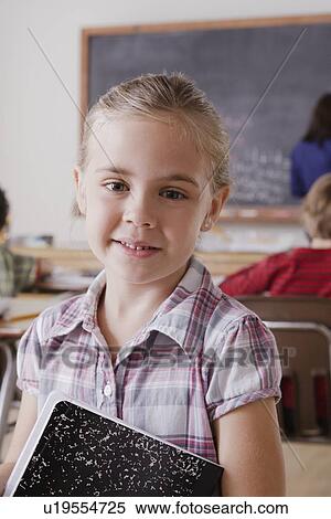 Stock Photography - Portrait of schoolgirl holding notebook. Fotosearch