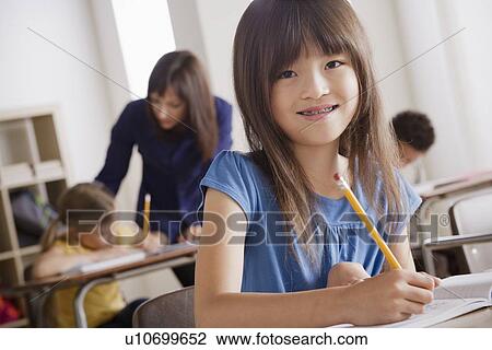 Portrait of schoolgirl in classroom View Large Photo Image Stock Image - Portrait of schoolgirl in classroom. Fotosearch