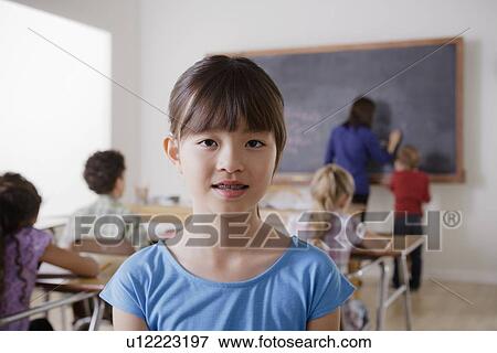 Portrait of schoolgirl in classroom View Large Photo Image Stock Photo - Portrait of schoolgirl in classroom. Fotosearch