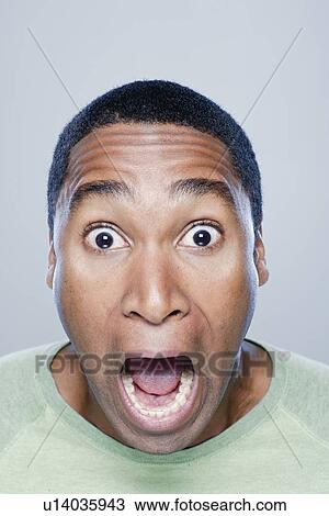 Stock Image - Portrait of screaming young man, studio shot. Fotosearch