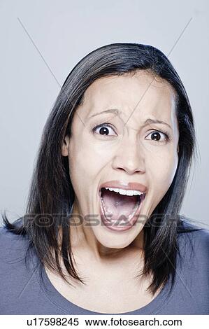 Portrait of screaming young woman, studio shot View Large Photo Image Stock Photography - Portrait of screaming young woman, studio shot. Fotosearch