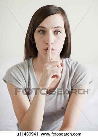 Stock Image - Portrait of secretive young woman . Fotosearch